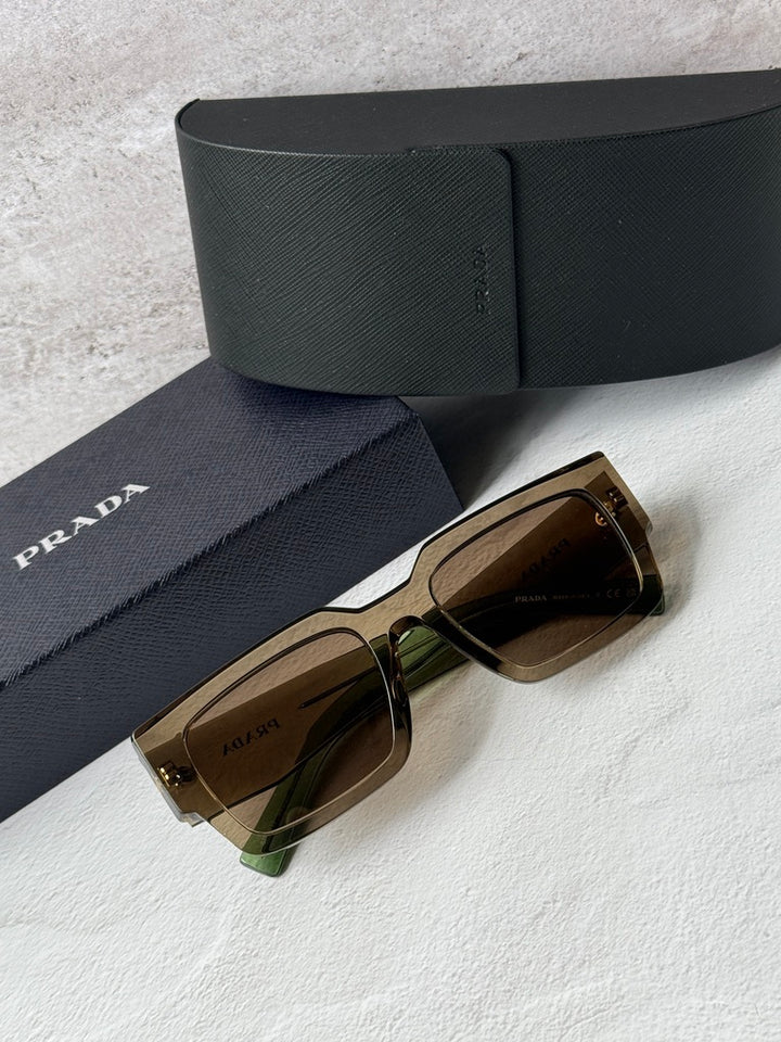 Prada sunglasses with transparent brown frames, brown lenses, with navy case