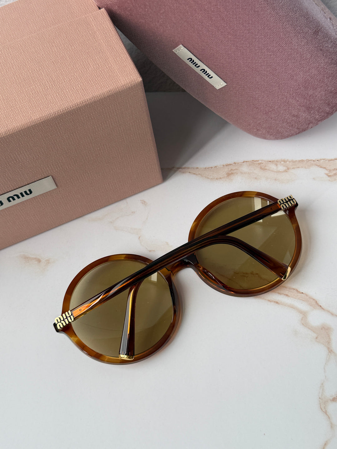 Miu Miu round sunglasses, brown tortoiseshell frames, gold-tone stud hinges
