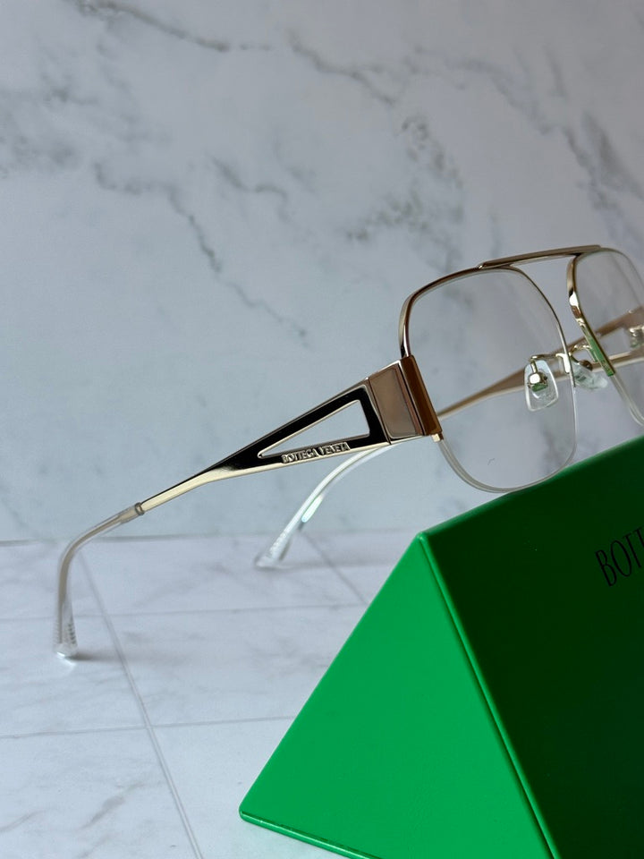 Gold-tone aviator frames with clear lens fronts and slim metal temple arms