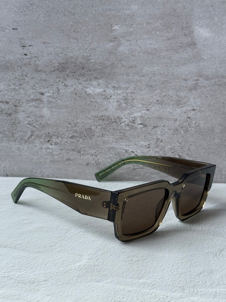Prada rectangular sunglasses with transparent brown frames, dark brown lenses, green temples