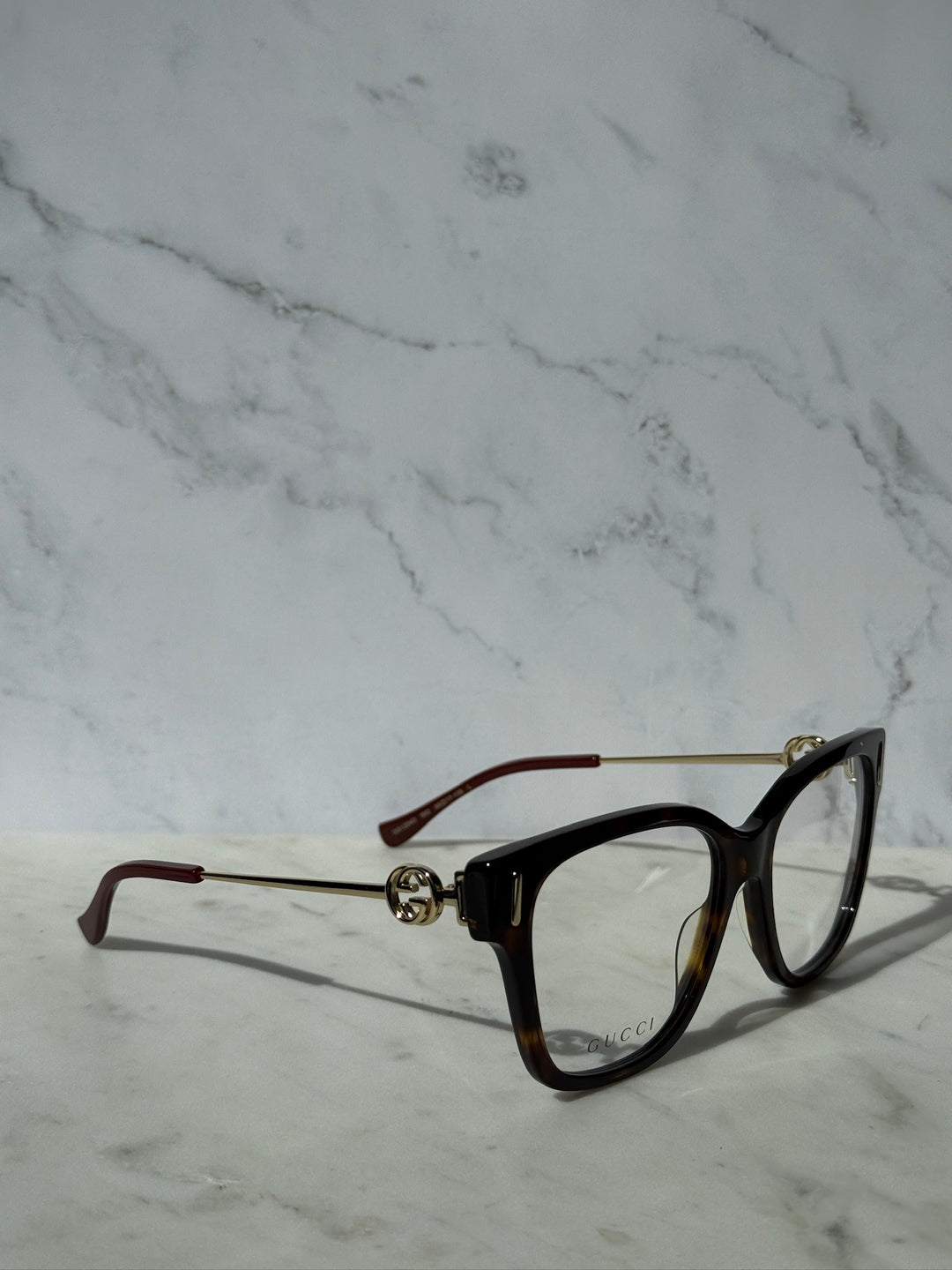 Gucci Havana brown eyeglasses, side view with gold hinge detail