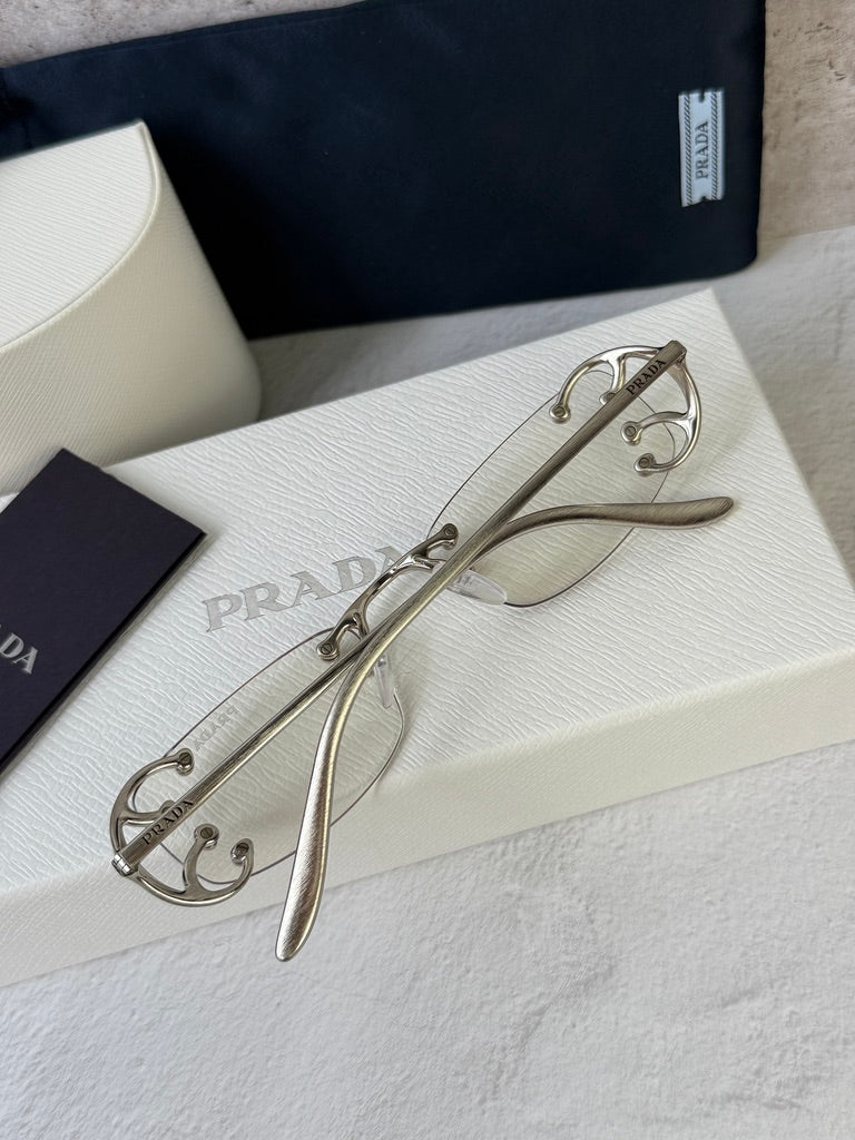 Prada PR C57S Rimless Sunglasses in Silver Bluelight