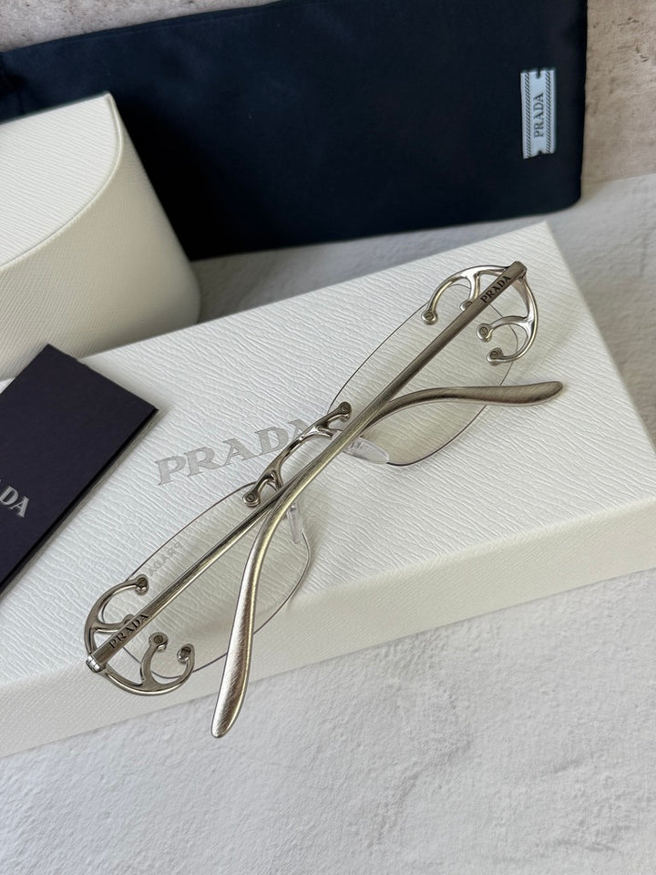 Prada PR C57S Rimless Sunglasses in Silver Bluelight