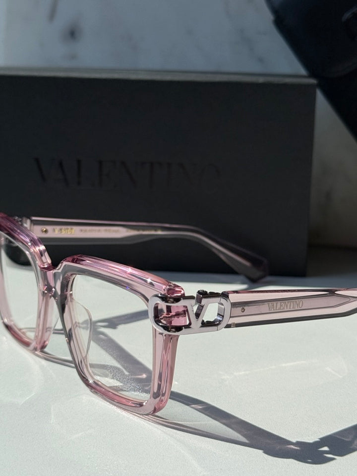 Pink square eyeglasses with clear lenses and chrome V logo bridge detail