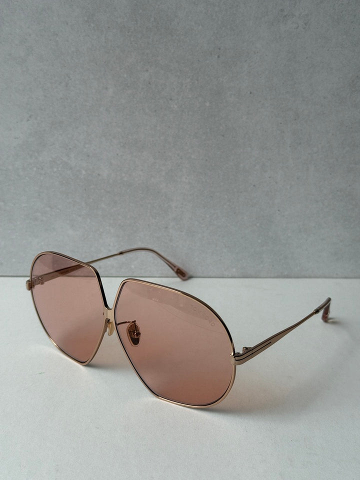 Rose gold oversized sunglasses with pink-tinted lenses, thin metal frame and bridge