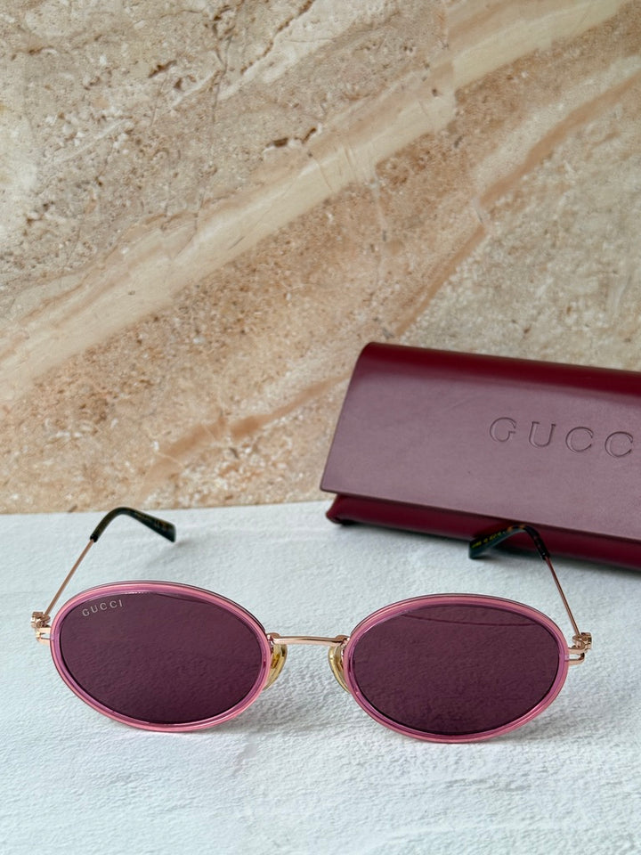 Gucci oval pink sunglasses with dark lenses and pink carrying case