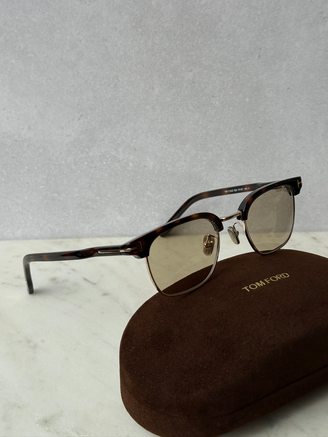 Dark Havana brown sunglasses with brown tinted lenses and gold hinges, with soft case