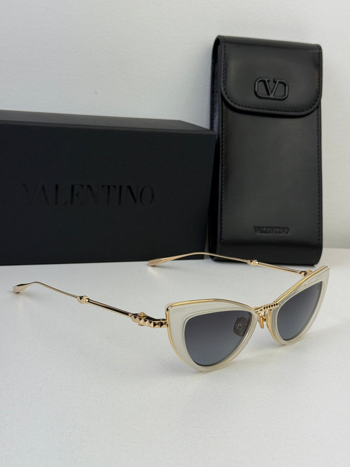 White cat-eye sunglasses with gold-tone arms and gray lenses with black case