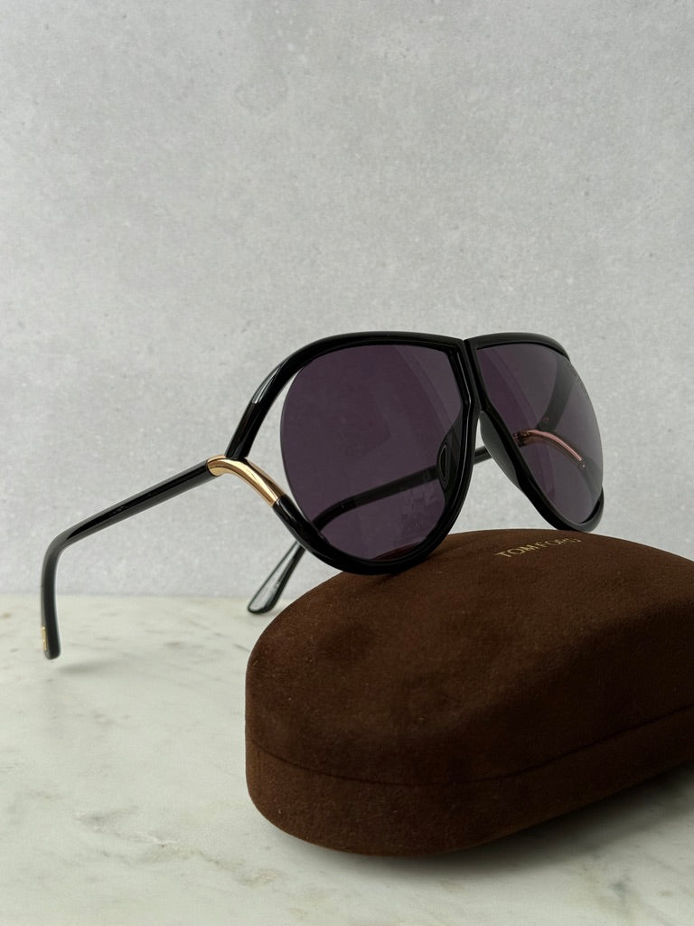 Black aviator sunglasses with dark purple lenses and gold-tone bridge