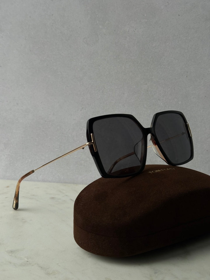 Black polarized sunglasses with thick square frames and gold-tone metal temples