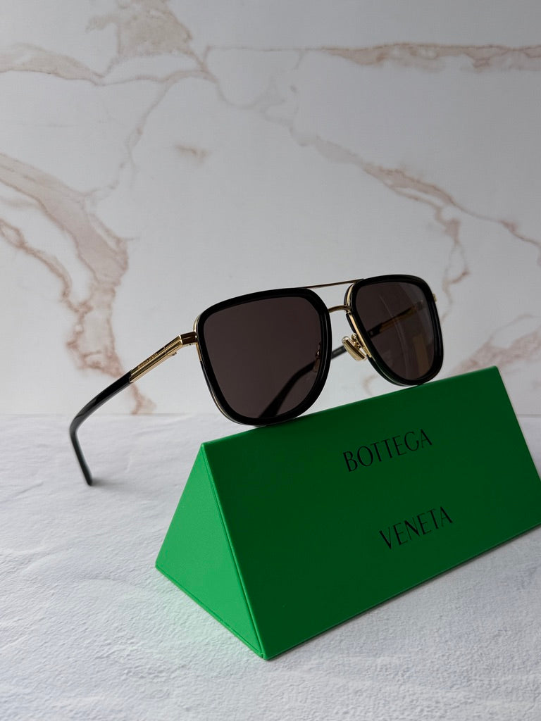 Black squared aviator sunglasses with dark lenses and gold-tone metal accents