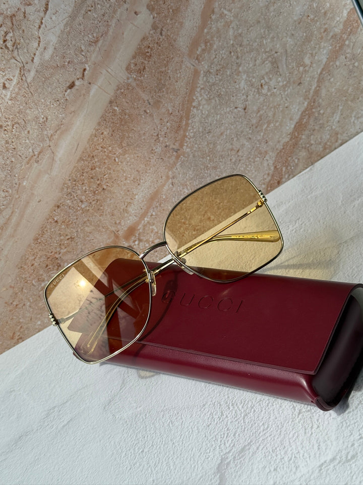 Gucci gold-tone square sunglasses with amber tinted lenses and red case