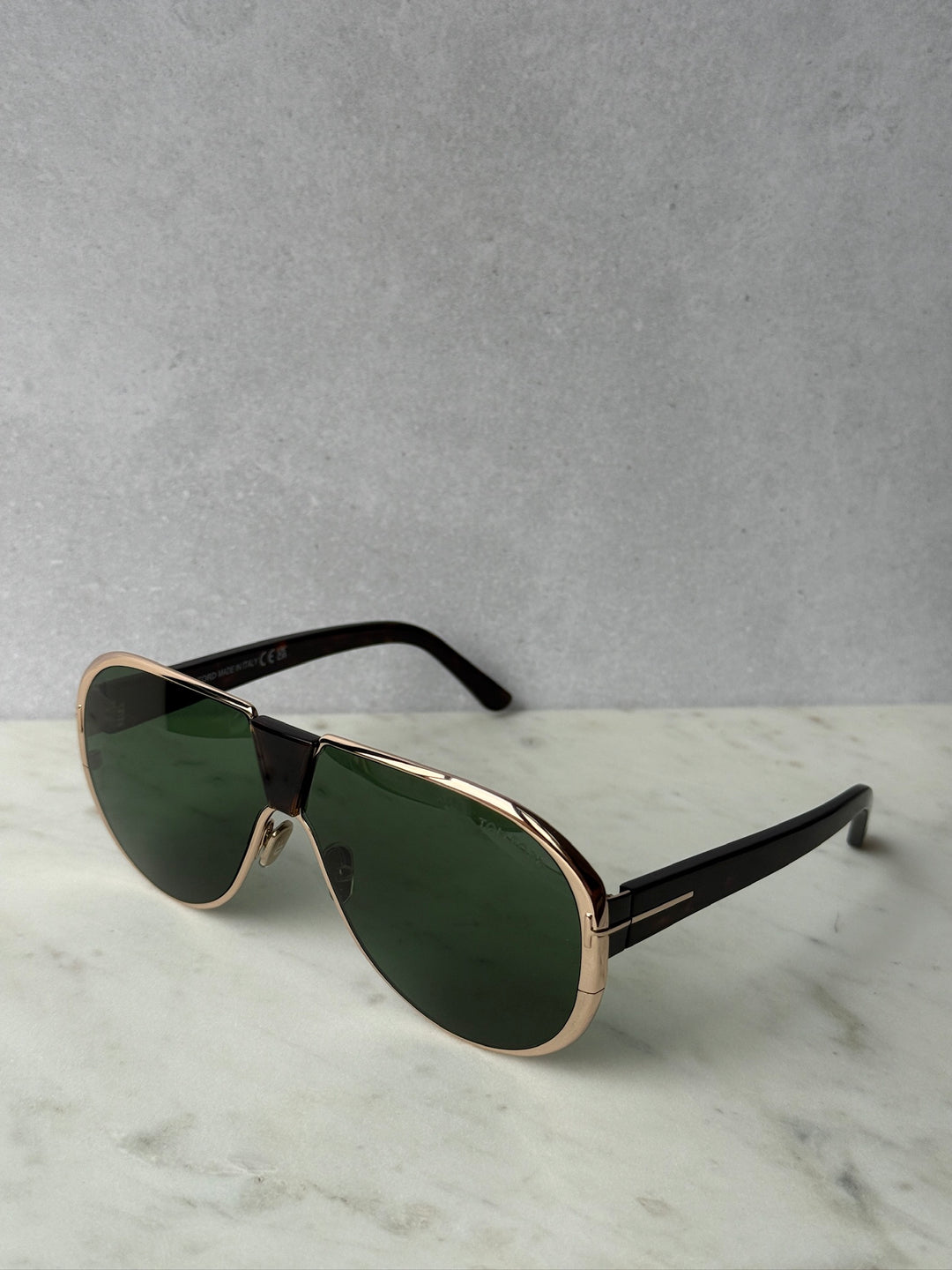 Gold aviator sunglasses with green lenses and black temple tips, angled view, Vincenzo
