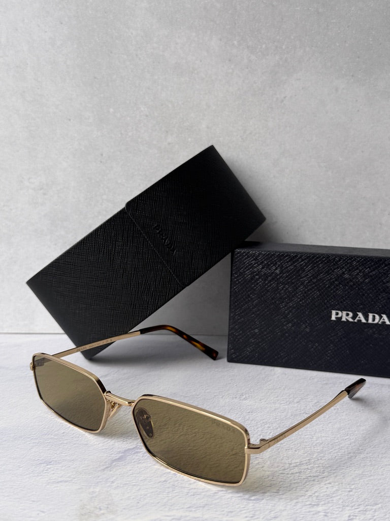 Gold metal rectangular sunglasses with brown-tinted lenses, side view, black case.