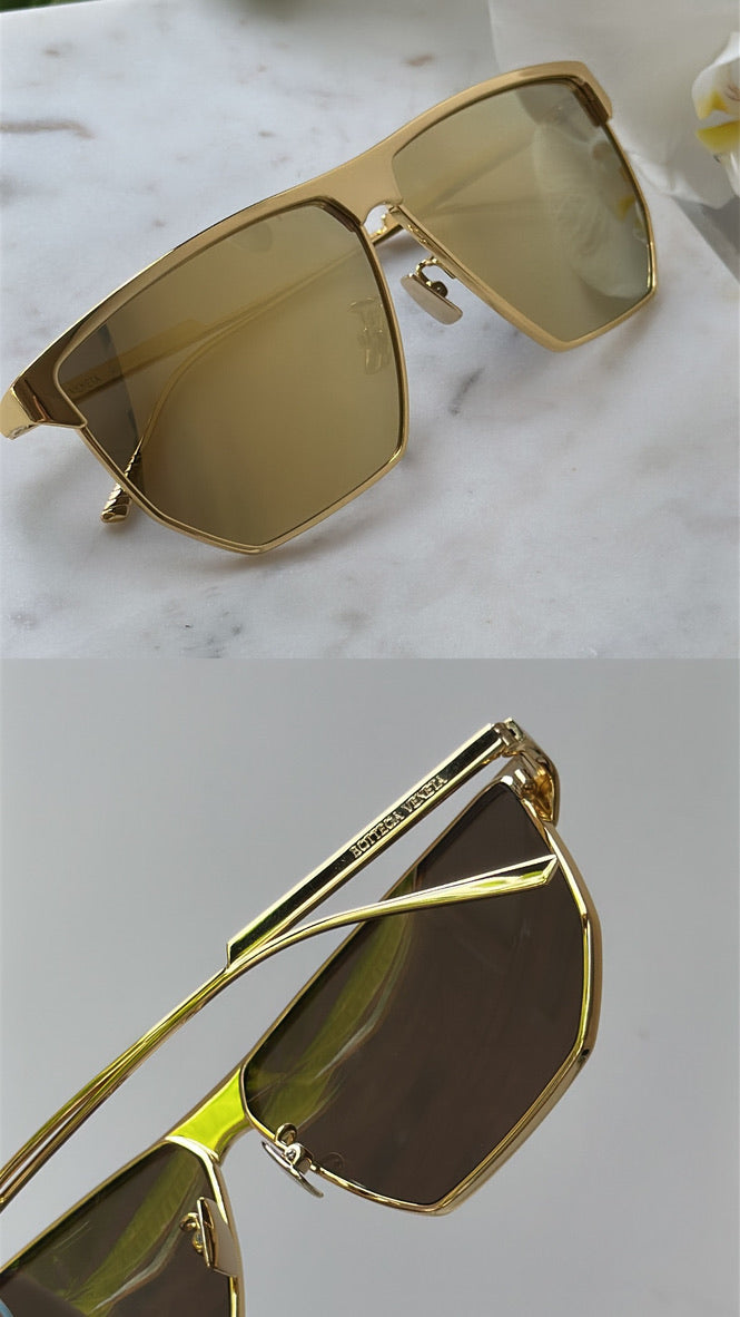 Gold metal aviator sunglasses close-up with angular frames and tinted lenses