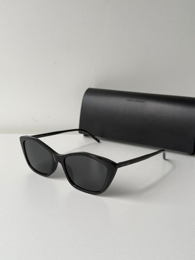 Black cat-eye sunglasses with dark lenses, side profile view