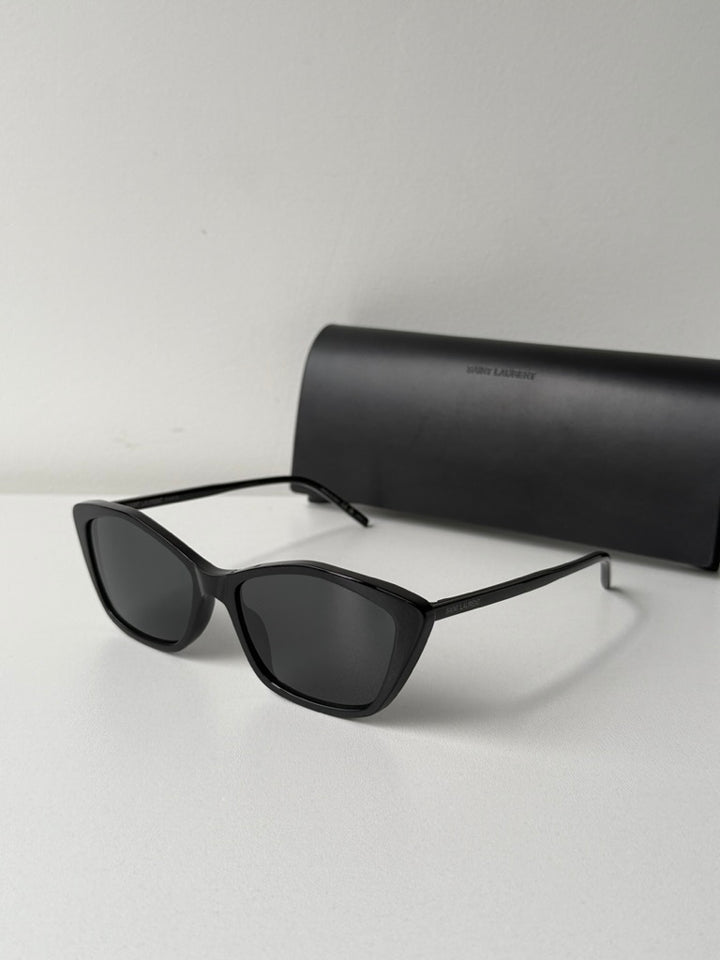 Black cat-eye sunglasses with dark lenses, side profile view