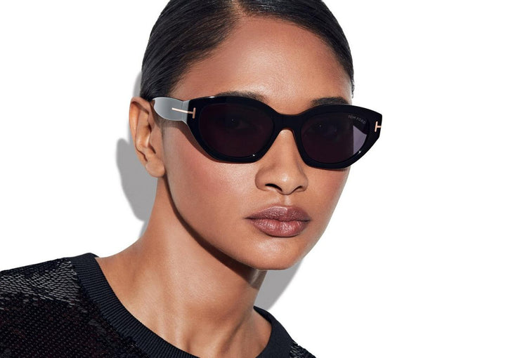 Tom Ford black cat-eye sunglasses worn, with dark lenses and gold-tone logo hinge