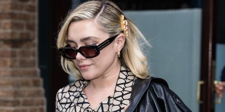 Dark sunglasses on model, black frame with square lenses and studded side arms