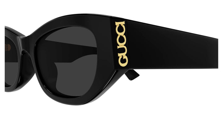 Side view of black slim sunglasses with dark lenses and gold GG temple logo
