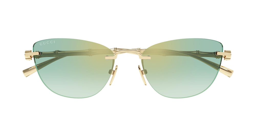 Cat-eye sunglasses with gold metal frame and green tinted lenses