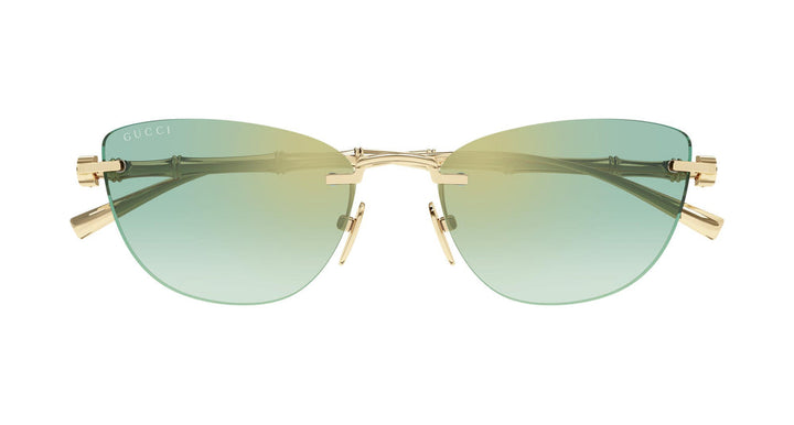 Cat-eye sunglasses with gold metal frame and green tinted lenses