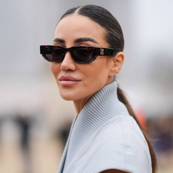 Black Greeley sunglasses with dark lenses on woman, classic square frame