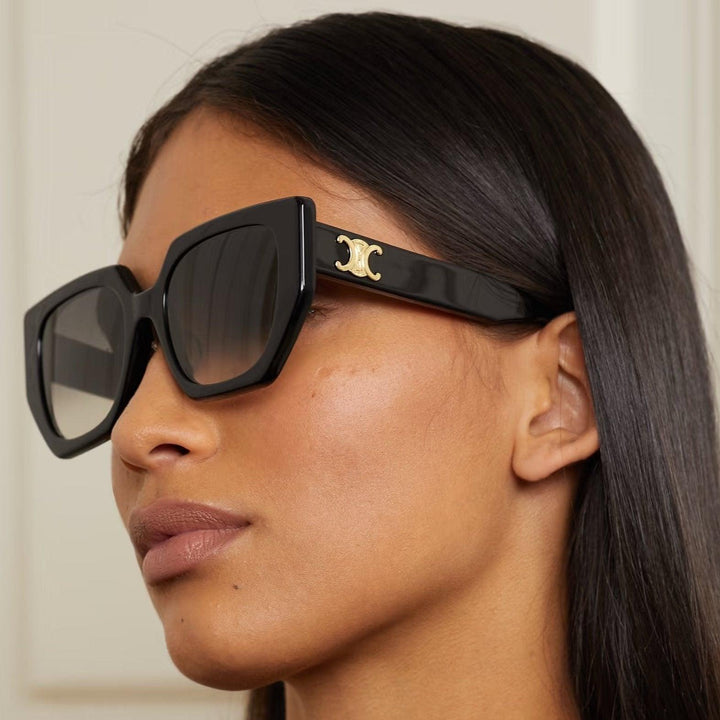 Celine black squared cat-eye sunglasses on model with gold temple emblem visible
