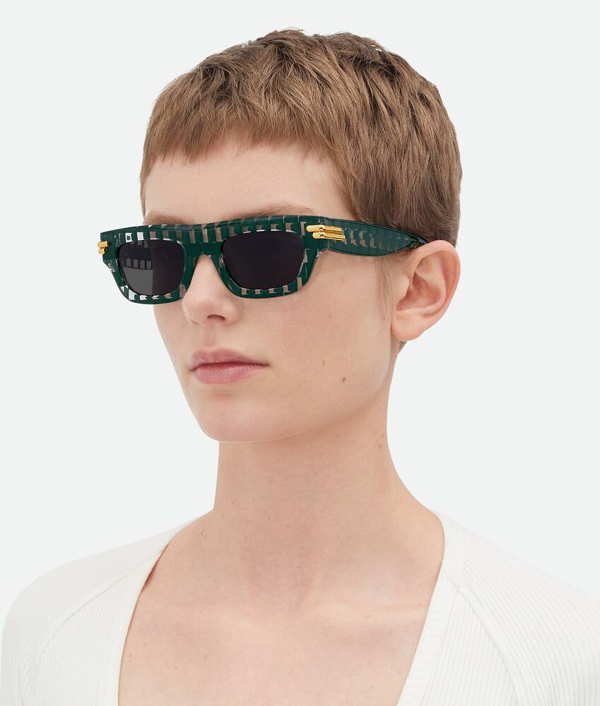 Bottega Veneta unisex sunglasses with green braided frame and dark lenses
