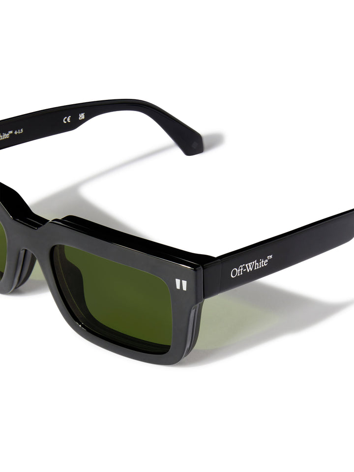 Clip-on sunglasses, black frames with dark green lenses, angled side view