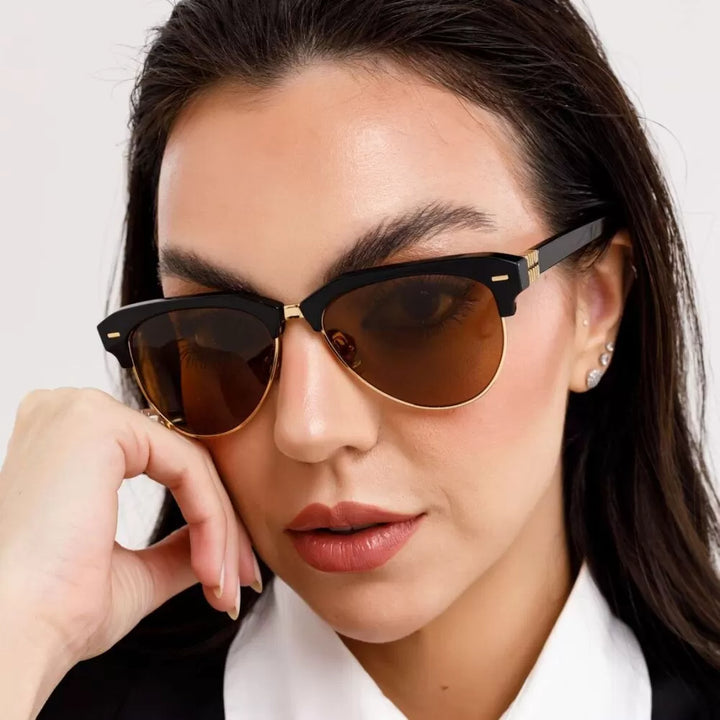 Miu Miu black cat-eye sunglasses with brown tinted lenses on a woman