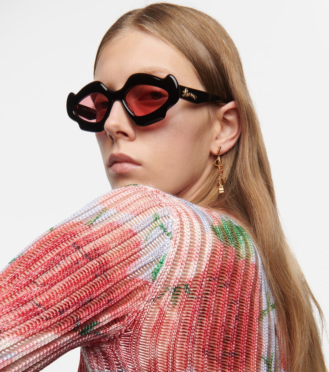 Black sunglasses with pink tinted lenses; gold &
