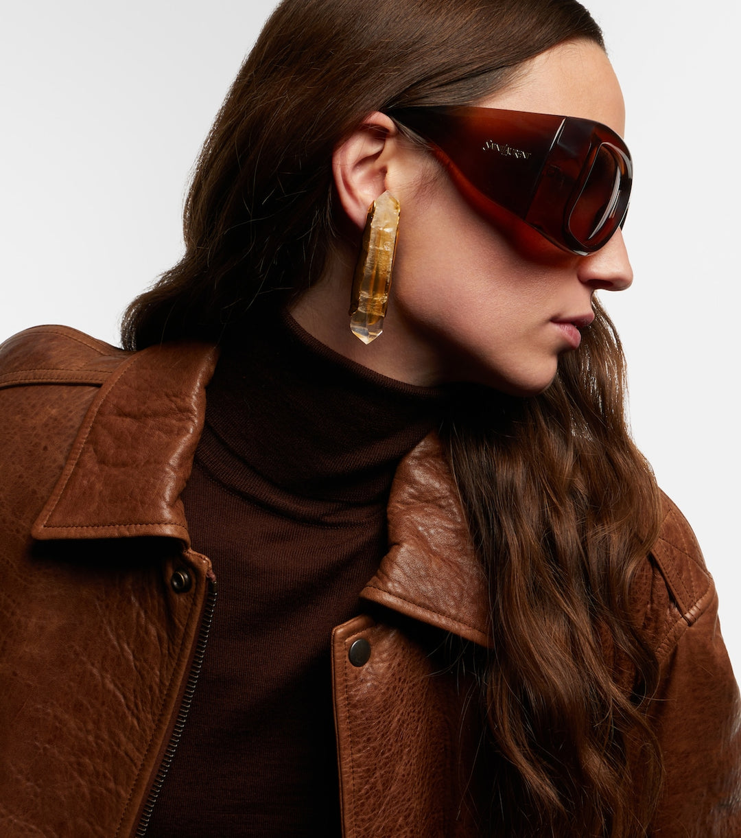 Brown Howl sunglasses with dark lenses, curved frame, and logo on temples.