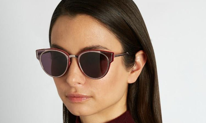Dior Sculpt sunglasses on model with silver-pink frames and purple-tinted lenses