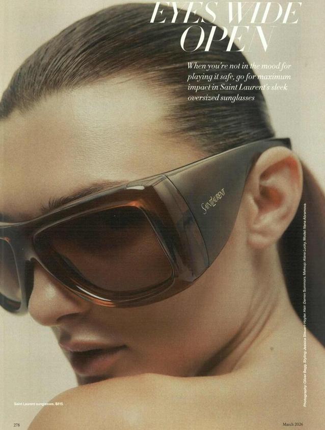 Oversized brown Howl sunglasses with dark lenses, worn with visible side logo.