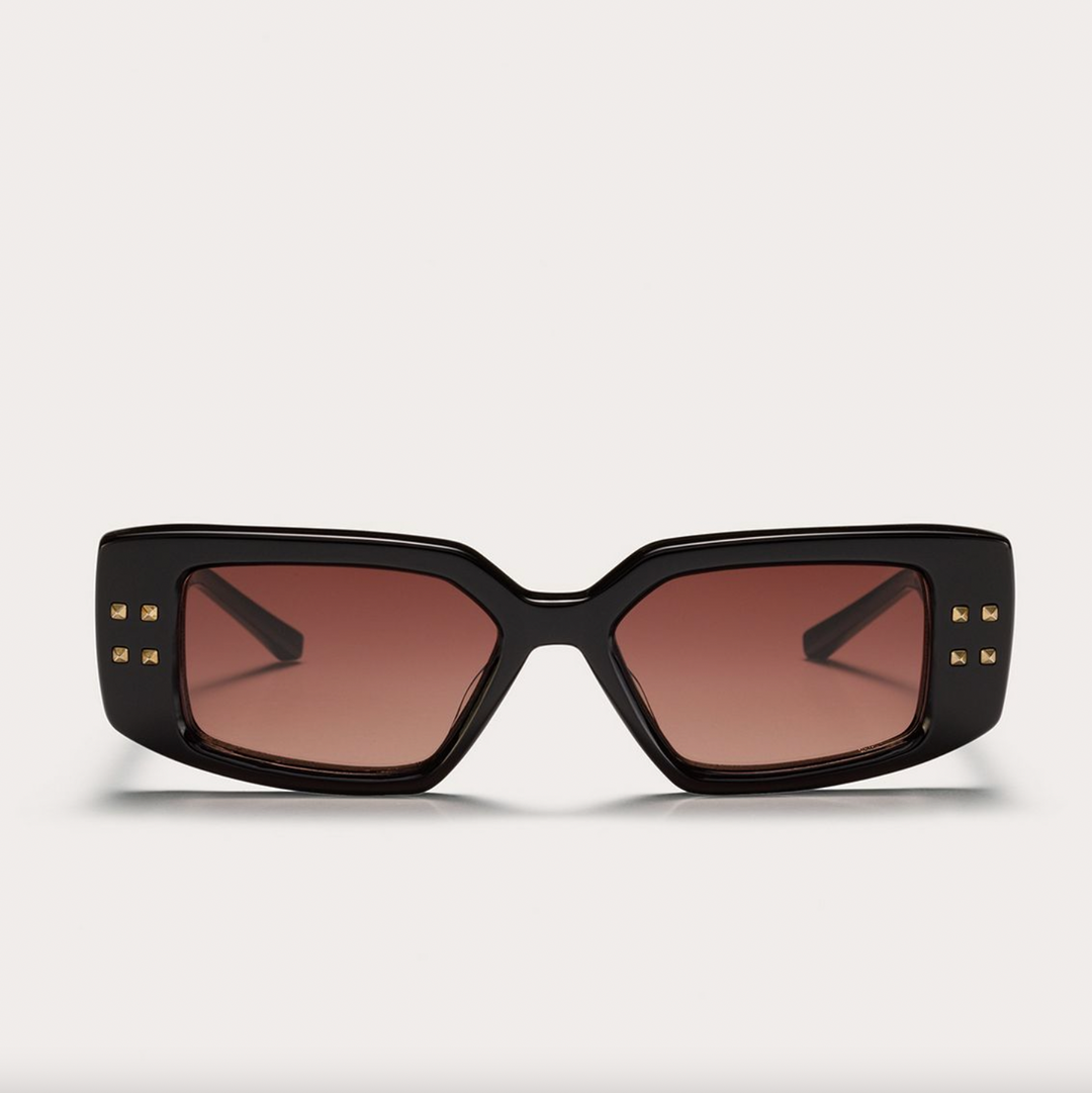Black oversized square sunglasses with brown gradient lenses and gold stud accents