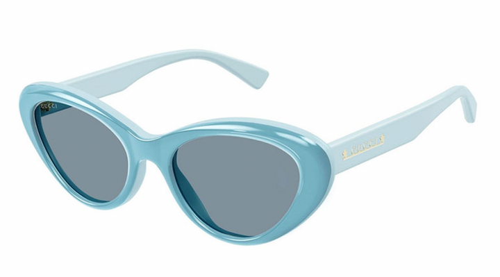 Gucci blue cat-eye sunglasses with dark lenses, translucent frame, curved temples