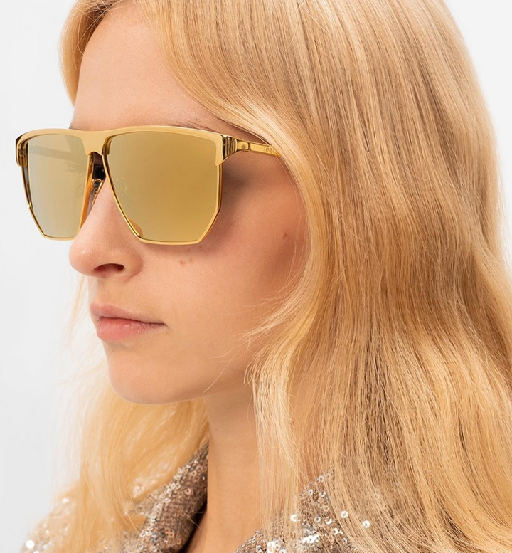 Gold metal aviator sunglasses with mirrored yellow lenses, side profile