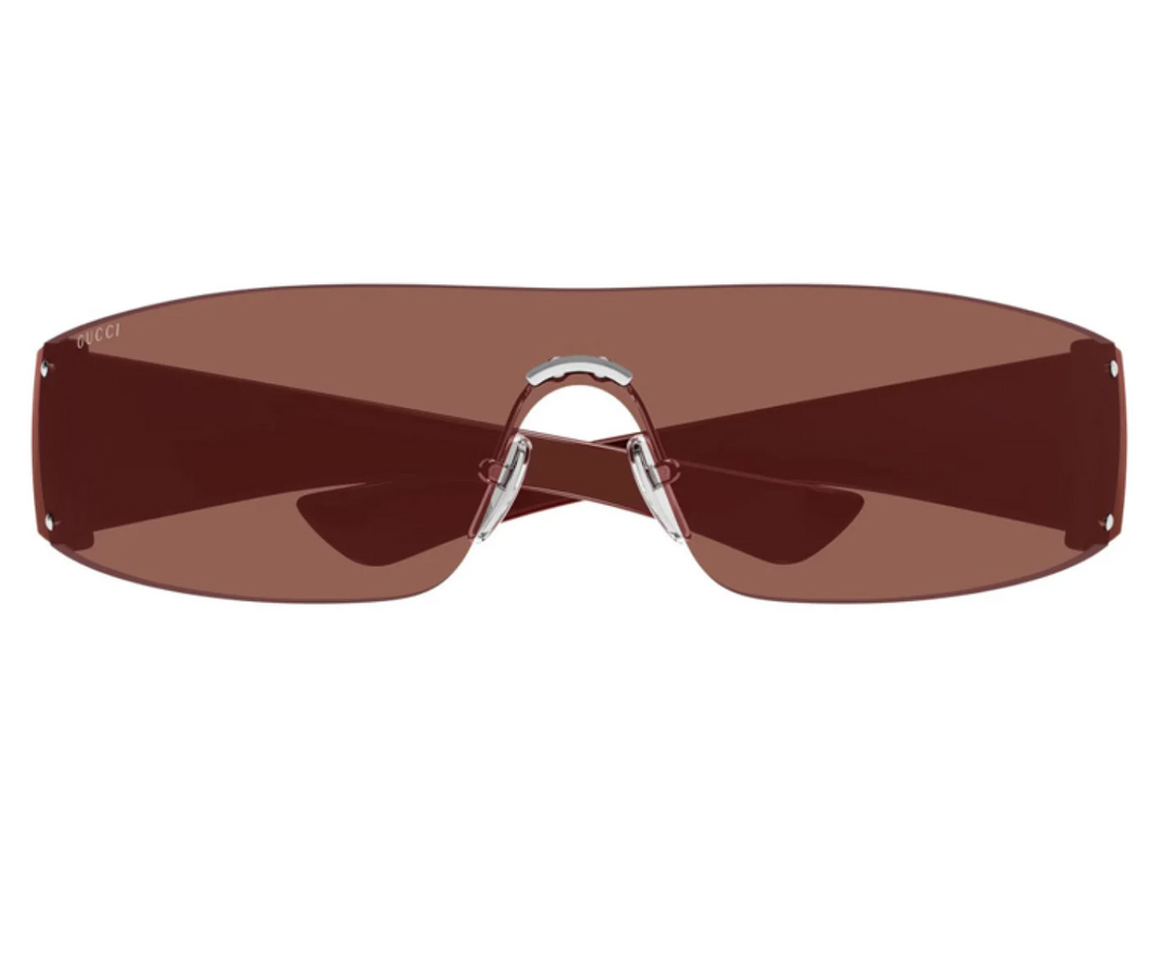 Rimless burgundy sunglasses with wide tinted lenses and metal bridge