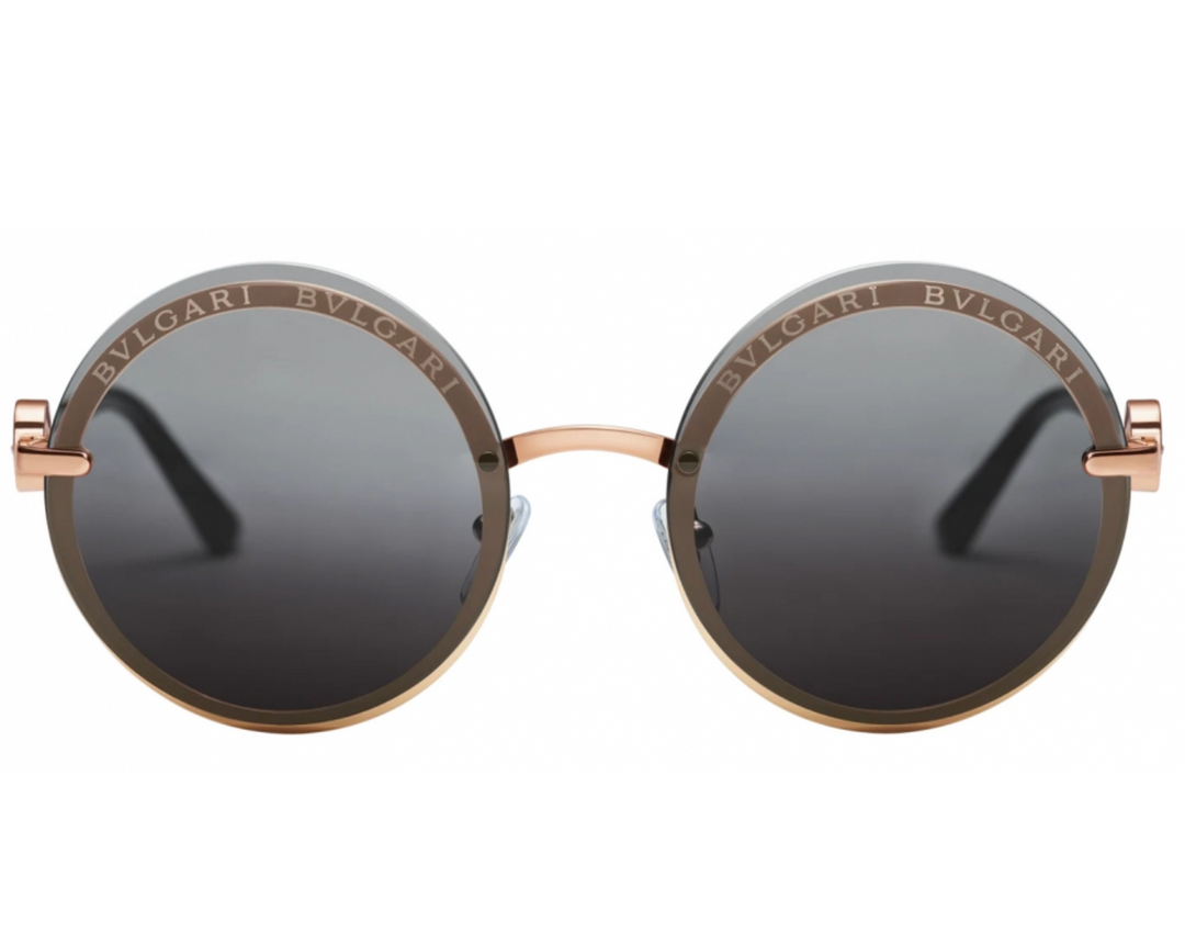 Front view of round grey-tinted sunglasses with rose-gold metal frames and dark lenses