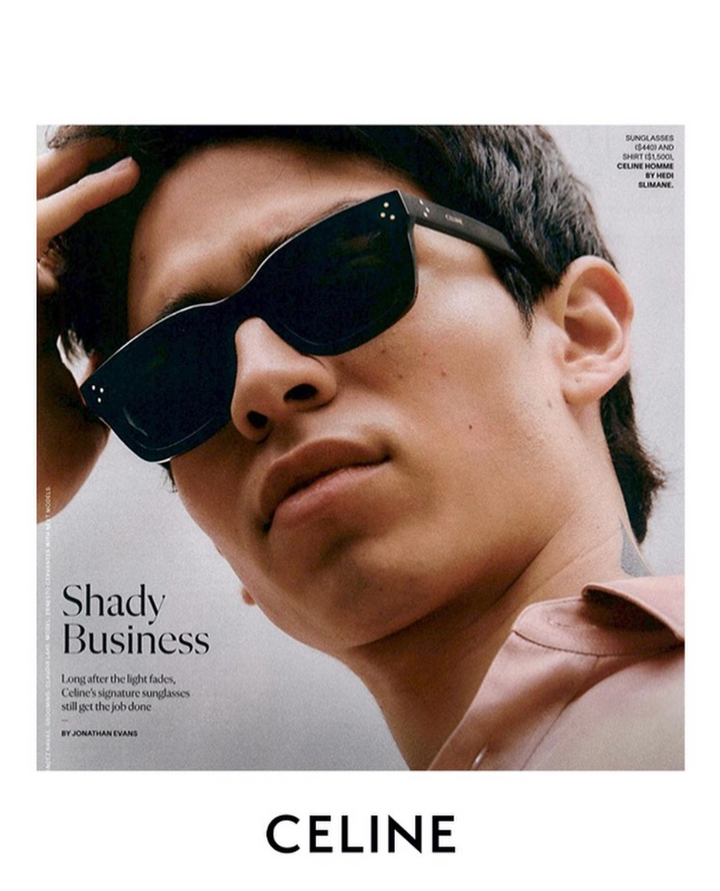 Black unisex sunglasses on model face, dark lenses, angular frame and studs