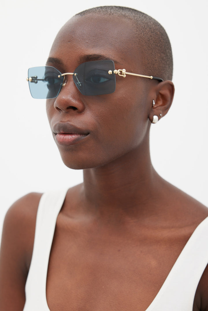 Tiffany &amp; Co rimless sunglasses with blue-tinted lenses and gold metal temples