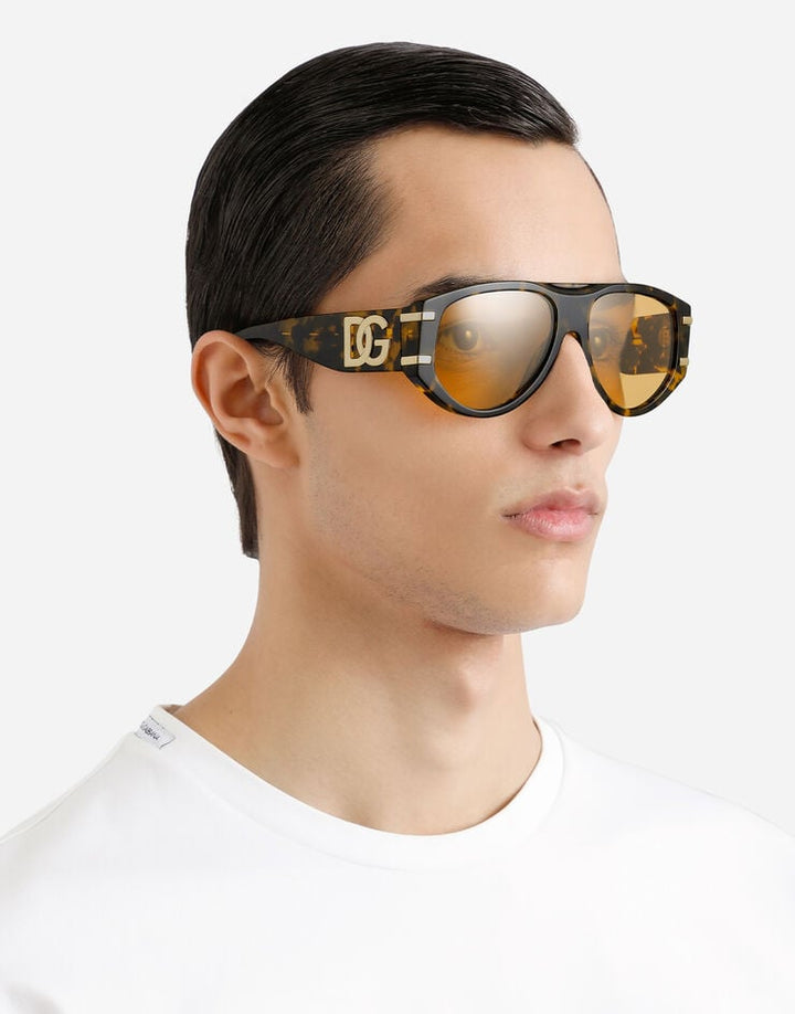 DG4499 aviator sunglasses worn on face; tortoiseshell frame and gold lenses