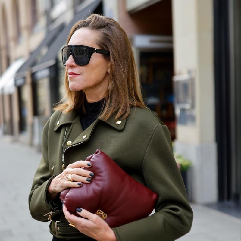 Black skull sunglasses on a woman, dark tinted lenses and thick square frame