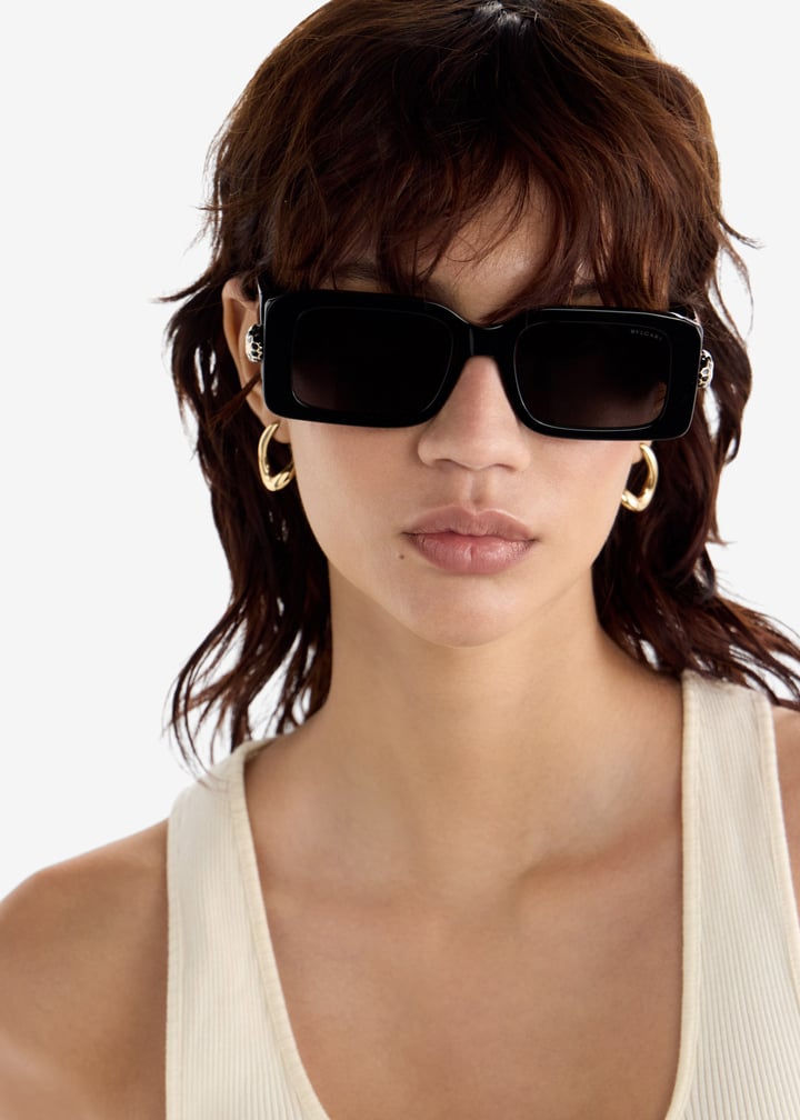 Black rectangular sunglasses with dark lenses, Bvlgari logo and gold snake detail