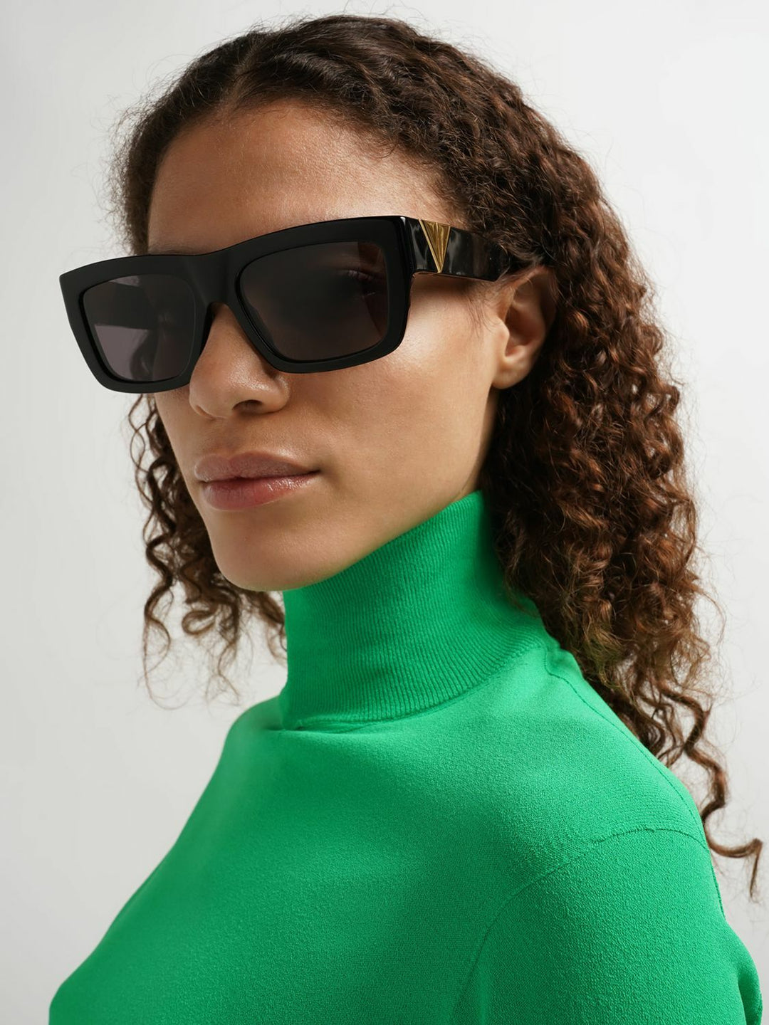 Bottega Veneta BV1178S black sunglasses in profile view with tinted lenses and gold tips