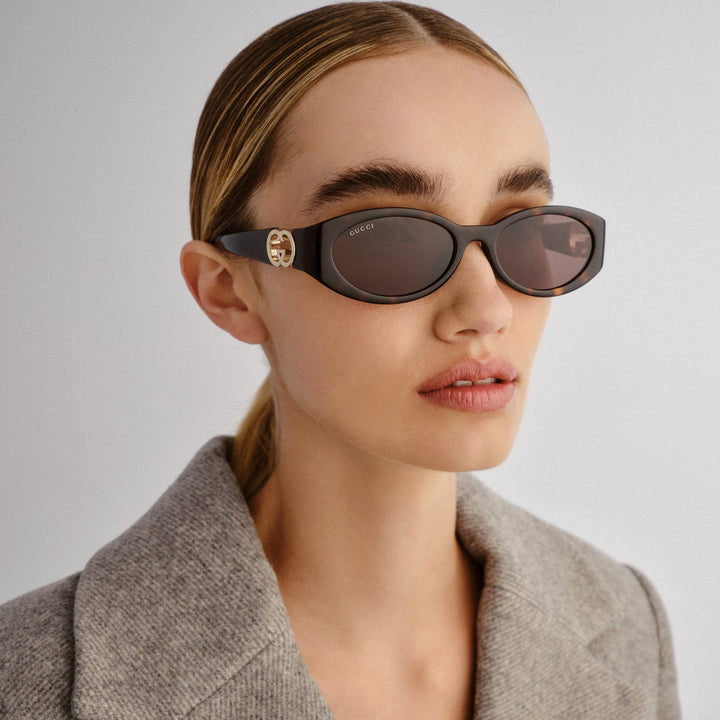 Gucci oval sunglasses with Havana brown frame, GG logo temples, dark lenses