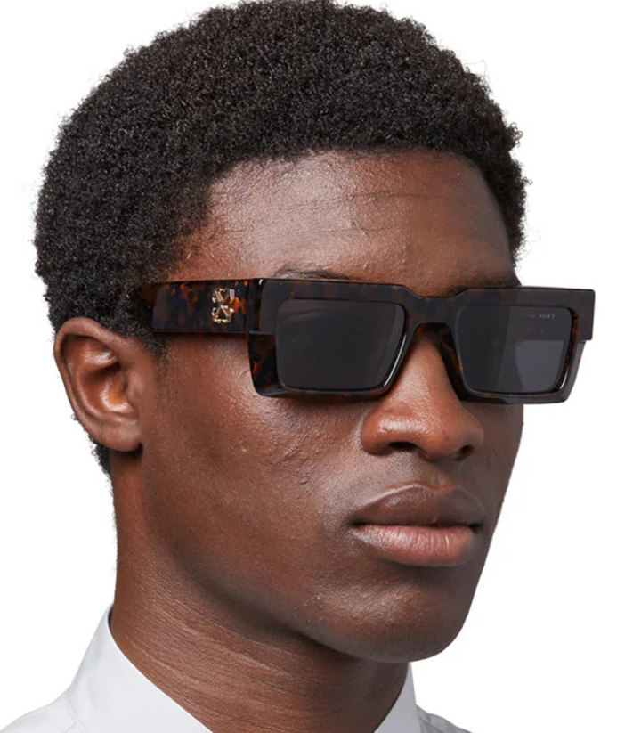 Off White Moberly sunglasses on face, havana brown tortoiseshell frames with dark lenses