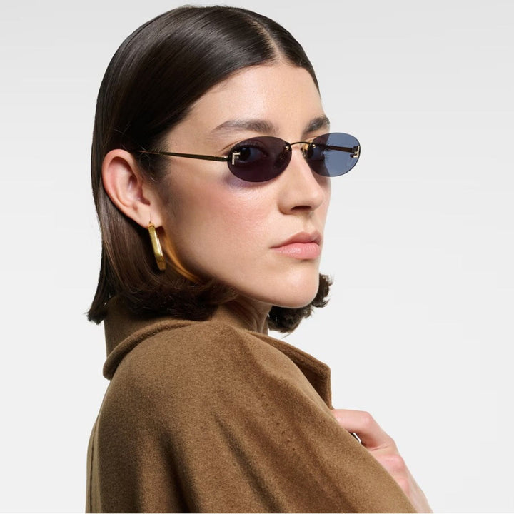 Fendi First rimless sunglasses on model, gold frame and blue lenses