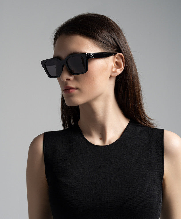 Black square sunglasses with dark lenses on model, Off-White logo on temples